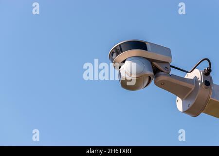 Street surveillance camera on sky background. Stock Photo