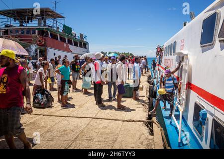 AUKI, SOLOMON ISLANDS - Dec 09, 2016: A crowd of people on Auki Wharf in Malaita Province of the Solomon Islands, waiting to board the Express Pelican Stock Photo