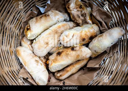 Traditional bread rolls with cheese and chorico meat baked in wood-fired oven, Faro, Portugal Stock Photo