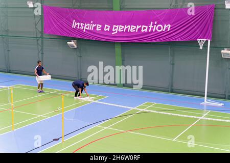 two players pick up shuttlecocks on badminton court at a badminton academy Essex England UK Stock Photo