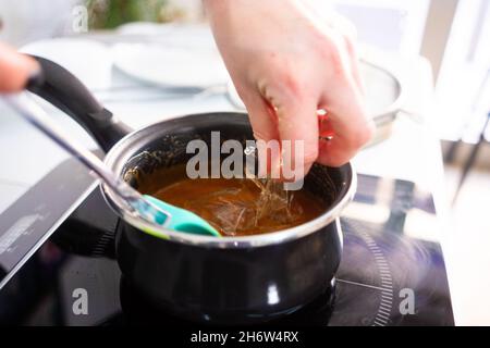 Pastry maker making chocolate for making the cake. Stock Photo