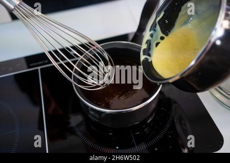 Pastry maker making chocolate for making the cake. Stock Photo