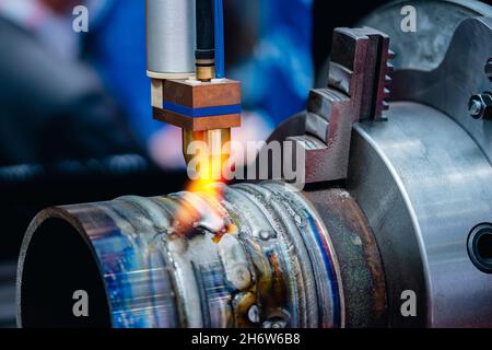 Finished weld seam on automatic CNC arc or gas welding equipment. Stock Photo