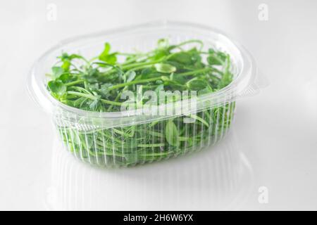 Fresh raw Microgreen sprouts baby beans pea and sunflower in box on white background. Stock Photo
