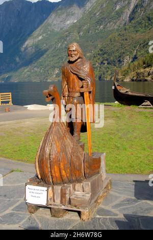 Wooden carving on public display, Gudvangen Fjordtell, Norway, with mountains beyond Stock Photo