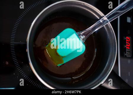 Pastry maker making chocolate for making the cake. Stock Photo