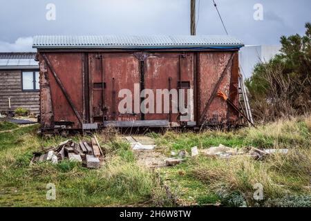 Wooden flaky rustic classic old vintage railway carriage converted and used for storage taken on the beach at Dungeness 14th of November 2021 Stock Photo