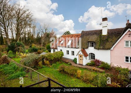 Kedington, Suffolk, November 19 2019: Traditional quaint British cottage in England. Thatched and pan tiled roof with entrance porch. Stock Photo