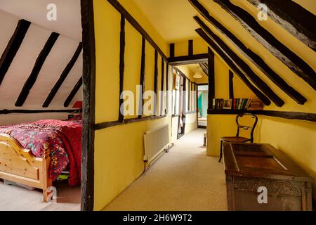 Kedington, Suffolk, November 19 2019: Landing bedroom in very old traditional British cottage with an abundance of exposed timbers and striking decor Stock Photo