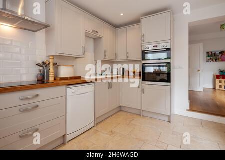 Cambridge, England - August 15 2019: Refitted kitchen with built in appliances inside Victorian era British home Stock Photo