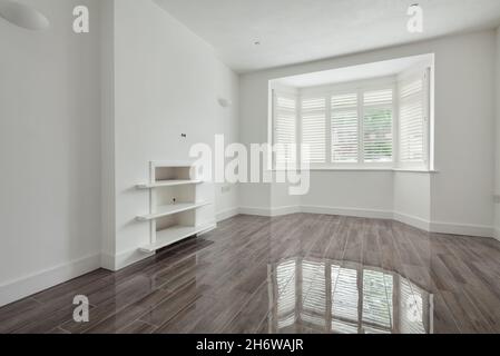 Cambridge, England - July 31 2019: Lounge with gloss ceramic tiled floor in newly renovated vacant home Stock Photo