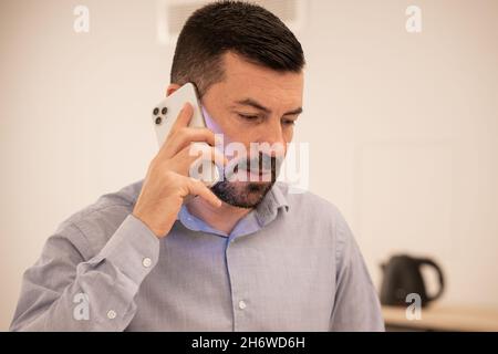 Young attractive businessman working with tablet and mobile phone. Stock Photo