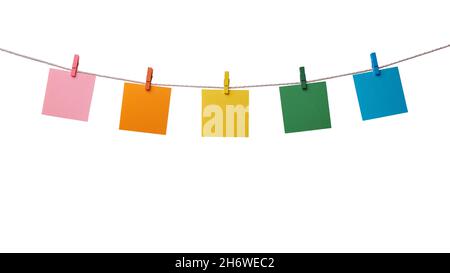 Five multicolored paper blank notes hanging on the rope with wooden clothespins isolated on white background Stock Photo