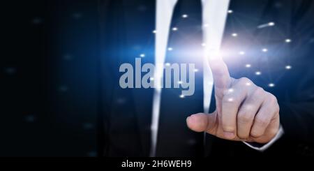 Businessman hand touching virtual screen on dark background with copy space Stock Photo