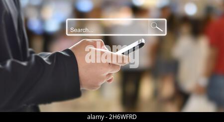 businessman hand searching browsing internet data in mobile phone. Business and technology concept. Stock Photo