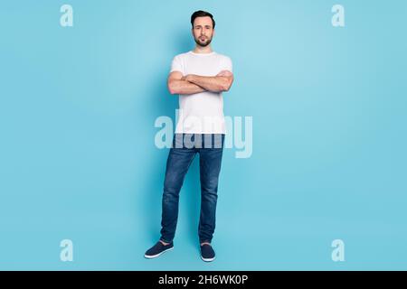 Full size photo of young person crossed arms look attentively camera isolated on blue color background Stock Photo