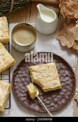 Apple pie slices with meringue served with coffee. Rustic style. Stock Photo