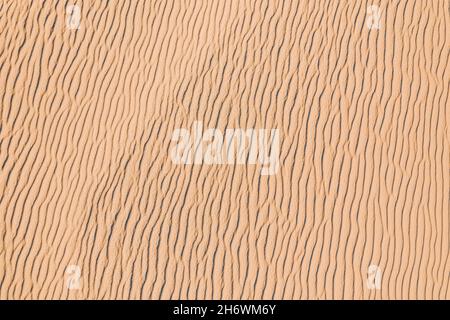 Wind wave vortices in sand background from aerial top view. Stock Photo