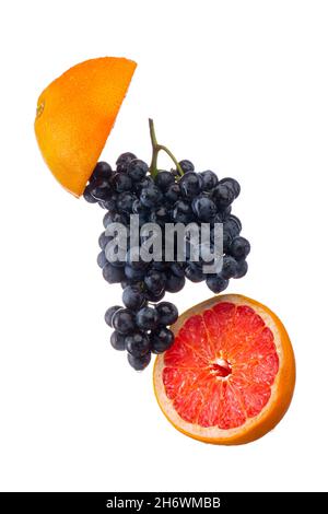 Dark blue grape with red grapefruit isolated on white background Stock Photo
