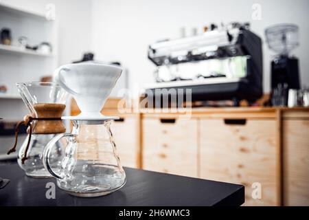 Alternative method of making coffee, funnel drip glasses with paper filter. Stock Photo