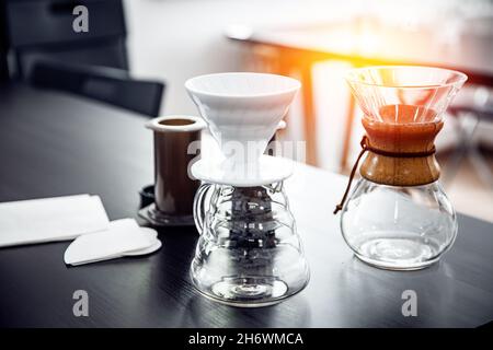 Aeropress coffee: barista press to device and coffee drops pours trought  aeropress to pot. Alternative coffee brewing method. Vertical photo  handsome Stock Photo - Alamy