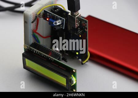 Arduino projects concept shown using an infrared sensor or IR sensor and LCD module that makes a functional tachometer with digital display readings Stock Photo