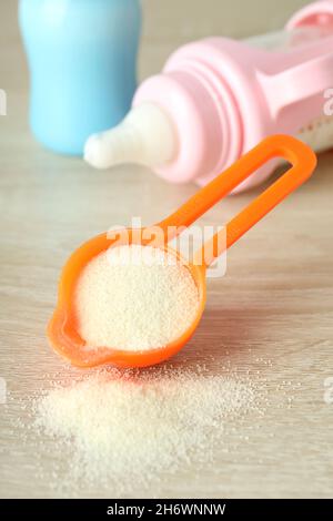 Concept of baby food with рowdered milk on wooden background Stock Photo