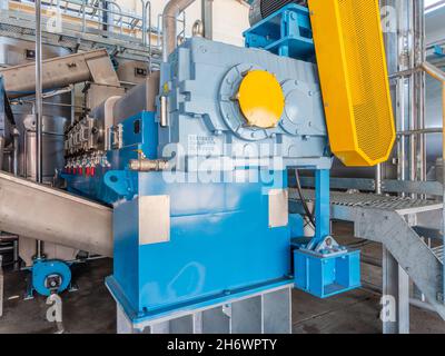 Twin screw press at fish meal plant. The plant processes byproducts from tuna canning into fish meal and tuna oil. The twin screw press separates soli Stock Photo