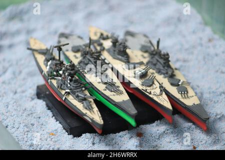 The lineup of miniature battleships consists of the enterprise carrier, the submarine, the battleship Musashi, the battleship Yamato Stock Photo