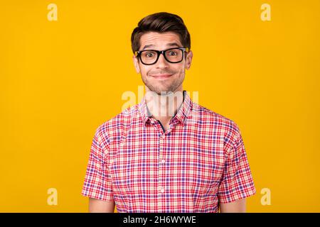 Portrait of attractive cheerful funny guy geek it specialist wearing specs isolated over vibrant yellow color background Stock Photo