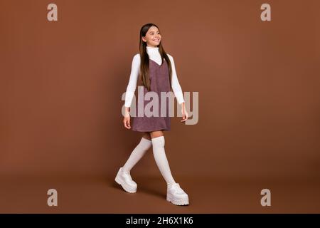 Full size profile side photo of young pretty girl look empty space curious isolated over brown color background Stock Photo