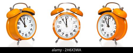 set of vintage orange alarm clocks isolated on white background. Countdown to midnight on clock face. Stock Photo