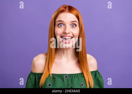 Photo of impressed funny young lady wear green blouse big eyes open mouth isolated purple color background Stock Photo
