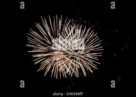 Looking up at fireworks against a black night sky Stock Photo