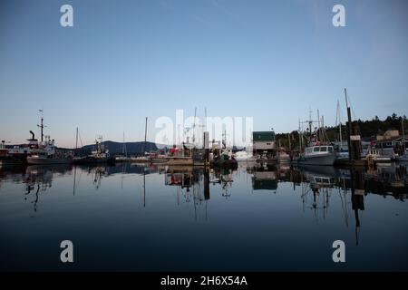 A fishing wharf near sunset with boats tied to the dock, Cowichan Bay, Vancouver Island, Canada Stock Photo