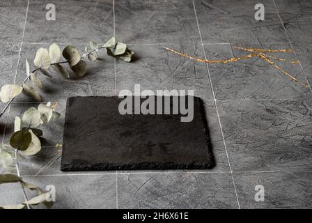 Putty dark gray background under the tiles in the style of kintsugi with black  slate board Stock Photo