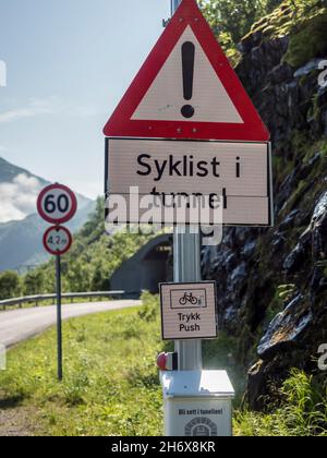 Warning system to show if cyclists are cycling in the next unlit tunnel, if button is pressed light signal flashes. Senja island, Norway Stock Photo