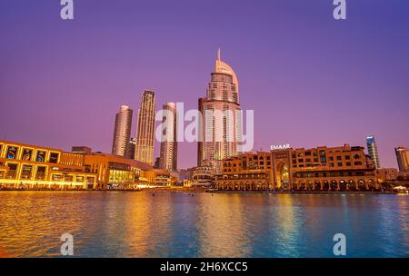 DUBAI, UAE - MARCH 3, 2020: Twilights are the most picturesque time with brightly illuminated glass high-rises around Burj Lake, on March 3 in Dubai Stock Photo