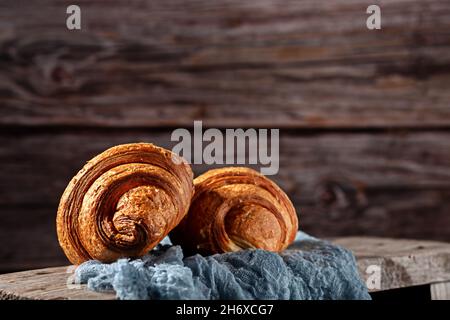 Freshly baked fragrant croissants on a wooden background Stock Photo
