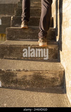 WA19789-00...WASHINGTON - Visitor climbing the steep steps at Kinzia Battery in historic Fort Worden in Port Townsend. Stock Photo