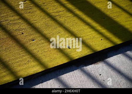 abstract yellow and grey concrete texture with diagonal shadow stripes Stock Photo