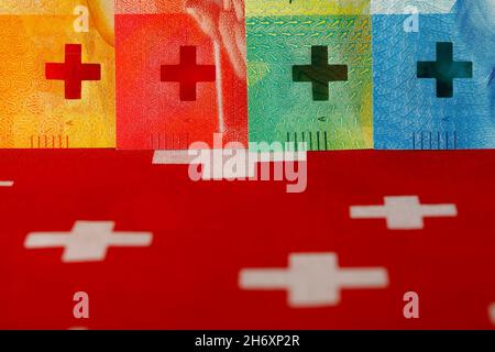 The Swiss flag symbols and a fragments of new Swiss banknotes of various denominations. These new banknotes are the eighth series of banknotes which w Stock Photo