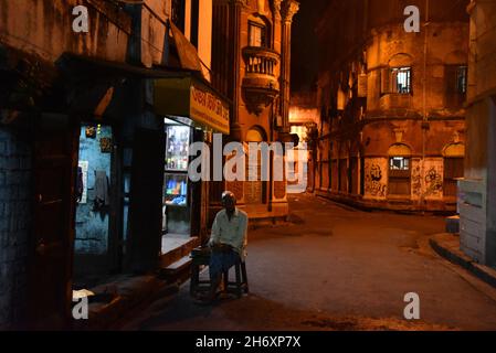 Streets at night in Kolkata. Kolkata (formerly Calcutta) is the capital of India's West Bengal state. Founded as an East India Company trading post, it was India's capital under the British Raj from 1773–1911. Today it’s known for its grand colonial architecture, art galleries and cultural festivals. It’s also home to Mother House, headquarters of the Missionaries of Charity, founded by Mother Teresa, whose tomb is on site. Stock Photo