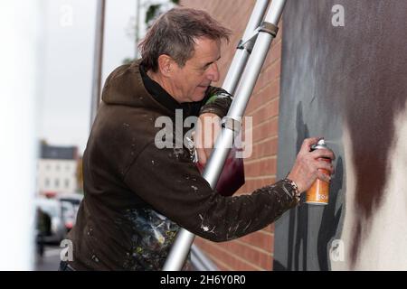 16th November 2021, Cheltenham, England, High Street Car Park. Artist Andy 'Dice' Davies painting a surprise mural for lead singer Jaz Coleman, from the 80s punk band Killing Joke. Stock Photo