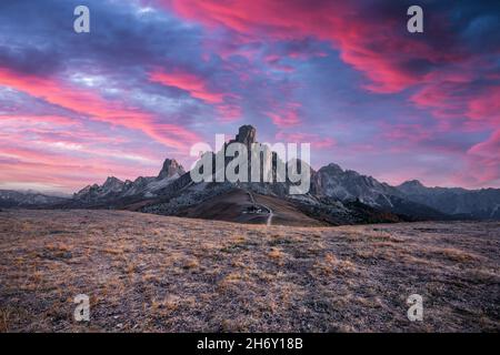 Picturesque landscape during incredible pink sunset in Italian Dolomites mountains. Passo Giau (Giau pass) with famous Ra Gusela and Nuvolau peaks on background. Dolomite Alps, Italy Stock Photo