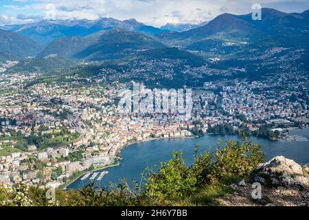 Lugano, Switzerland - October 6th 2021: View from Monte San Salvatore towards the city surrounded by mountains Stock Photo