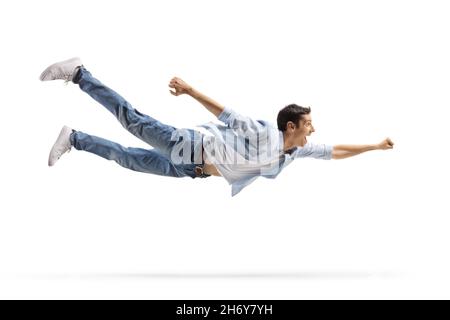 Casual young man in jeans flying isolated on white background Stock Photo