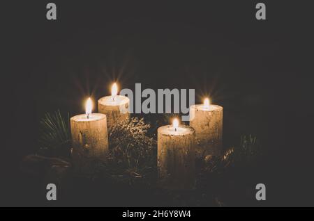 advent concept with four silver burning candle on black background Stock Photo