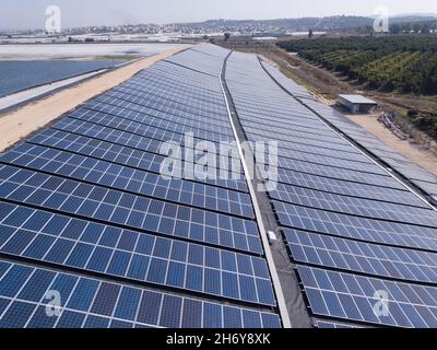 Solar panels installed on a water reservoir bank. Stock Photo