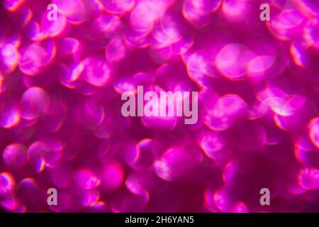 Texture created from oval purple objects. The effect was obtained by photographing the glitter surface in a macro scale without focusing. Stock Photo